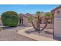 Inviting home exterior featuring a well-manicured yard and a pathway with accent lighting at 16313 W Escondido Ct, Surprise, AZ 85374