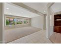 Bright living room featuring large windows with views of the landscaped exterior at 16313 W Escondido Ct, Surprise, AZ 85374