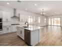 Spacious open kitchen with island, pendant lighting, stainless appliances, and ample cabinet space at 18174 W Ashley Dr, Goodyear, AZ 85338