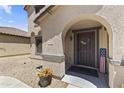 Inviting front entrance with arched doorway, decorative wreath, and an American flag accent at 18390 W Hayden Dr, Surprise, AZ 85374