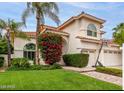 Stucco two-story home with tile roof, lush landscaping and paved walkway at 2026 E Cortez Dr, Gilbert, AZ 85234