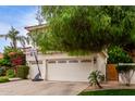 Charming home with a three-car garage, red tile roof, basketball hoop and mature landscaping at 2026 E Cortez Dr, Gilbert, AZ 85234