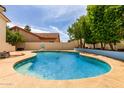Inviting backyard oasis with a sparkling blue pool, tanning deck and mature trees offering shade at 2026 E Cortez Dr, Gilbert, AZ 85234