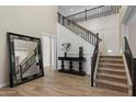 Grand foyer with staircase, wood floors, dark wood accents, and high ceilings, creating a welcoming space at 22925 N 46Th St, Phoenix, AZ 85050