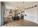 Spacious kitchen featuring white cabinets, stainless steel appliances, and a large center island at 22925 N 46Th St, Phoenix, AZ 85050