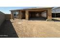 New home under construction, showcasing a spacious layout with attached garage and a large, open yard at 2300 E Spur Dr, San Tan Valley, AZ 85140