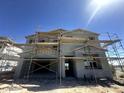 Two-story home under construction, showcasing its modern design and sturdy framework against a clear blue sky at 2325 E Homesteader Rd, San Tan Valley, AZ 85140