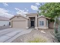 Charming single-story home featuring a two-car garage, desert landscaping, and a welcoming front entrance at 2579 E Camellia Dr, Gilbert, AZ 85296