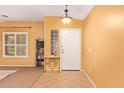 Bright entryway with tile flooring, a decorative table, and natural light from the window at 2610 E Leiber Ln, Phoenix, AZ 85024