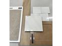 Interior design materials featuring wood flooring, neutral carpet, white tiles and hardware samples at 281 W Flax Dr, San Tan Valley, AZ 85140