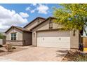 Garage exterior showcasing the warm tone, brick driveway, and meticulous landscaping at 3264 E Luna Dr, San Tan Valley, AZ 85143