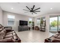Spacious living room with tile flooring, a large ceiling fan, and ample natural light at 3264 E Luna Dr, San Tan Valley, AZ 85143