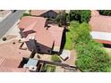 Aerial view of a home with a red tile roof, landscaped backyard, and a small jacuzzi in the corner at 3926 E Lavender Ln, Phoenix, AZ 85044