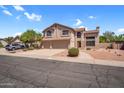 Beautiful two-story home with a three-car garage and desert landscaping, nestled in a residential neighborhood at 3926 E Lavender Ln, Phoenix, AZ 85044