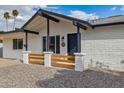 Close up of a front porch with a decorative wooden fence and brick columns at 405 E Cornell Dr, Tempe, AZ 85283