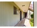 Close-up of an apartment entrance with a security door and window with blinds at 4610 N 68Th St # 409, Scottsdale, AZ 85251