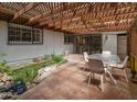 Inviting back patio with brick flooring, pergola, koi pond, and seating area at 4620 N 38Th Dr, Phoenix, AZ 85019