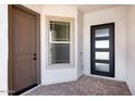 Modern front entry with a stylish door and a sidelight window for natural light at 5311 N 88Th Ave, Glendale, AZ 85305