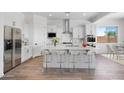 Bright kitchen features a large island with seating, stainless appliances, and white cabinetry at 5311 N 88Th Ave, Glendale, AZ 85305
