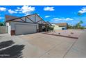 Spacious driveway leading to a two-car garage, complemented by desert-style landscaping at 6160 E Inglewood St, Mesa, AZ 85205