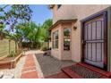 Backyard view with stepping stones, desert landscaping, and a charming side entrance to the home at 630 E Jensen St # 102, Mesa, AZ 85203