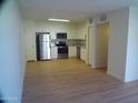 Open-concept space with kitchen featuring stainless steel appliances and hardwood style floors at 720 S Dobson Rd # 95, Mesa, AZ 85202