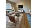 Cozy living room with contemporary furniture, hardwood flooring, and a large TV at 720 S Dobson Rd # 95, Mesa, AZ 85202