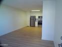Spacious living room with hardwood-style floors leading to a modern kitchen at 720 S Dobson Rd # 95, Mesa, AZ 85202