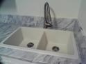 A close up of a dual basin white sink with marble countertops and modern faucet at 720 S Dobson Rd # 95, Mesa, AZ 85202