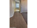 Open hallway with elegant tile flooring leading to a light-filled living area at 8582 W Rue De Lamour --, Peoria, AZ 85381