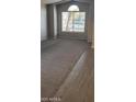 Bright living room with a large window, plush carpet, and fresh neutral paint at 8582 W Rue De Lamour --, Peoria, AZ 85381