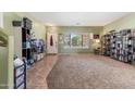 Bright living room with natural light, featuring carpet and tile flooring with a view of the entryway at 13313 W Indianola Ave, Litchfield Park, AZ 85340