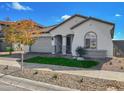 Beautiful home with a two-car garage, gray-toned exterior, tile roof, and lush artificial turf landscaping at 15787 W Mariposa Grande St, Surprise, AZ 85387