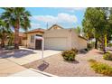 Charming home with a two-car garage, desert landscaping, and a neatly maintained front yard at 1601 E Cindy E St, Chandler, AZ 85225