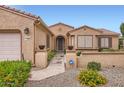 Well maintained single Gathering home featuring desert landscaping, covered entrance and updated lighting at 17009 W Eureka Springs Dr, Surprise, AZ 85387