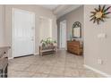 Inviting foyer featuring neutral paint, tile flooring and a sunburst mirror as decorative elements at 18247 N 168Th Cir, Surprise, AZ 85374