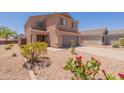 Charming two-story home with neutral exterior, well-maintained yard, and inviting curb appeal at 23929 W Twilight Trl, Buckeye, AZ 85326