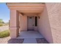 Inviting front porch featuring neutral tones, a secure front door, and low-maintenance landscaping at 23929 W Twilight Trl, Buckeye, AZ 85326