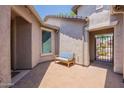 Private courtyard with a blue bench, paver flooring and stucco walls, offering a cozy outdoor space at 2543 W Rabjohn Rd, Phoenix, AZ 85085