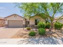 Charming single-Gathering home featuring a desert-landscaped front yard, a two-car garage, and a stone-accented facade at 2543 W Rabjohn Rd, Phoenix, AZ 85085