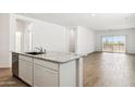 Modern kitchen featuring granite countertops, stainless steel appliances, and wood flooring at 25467 W Graham Trl, Buckeye, AZ 85326