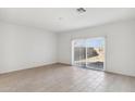 Bright living room with sliding glass doors leading to the backyard at 25479 W Graham Trl, Buckeye, AZ 85326