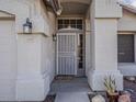 Close up of the front door with security door, and a front door light. House number is 2550 at 2550 E Caballero St, Mesa, AZ 85213