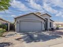 Charming single-story home with a two-car garage, neutral paint, and low maintenance desert landscaping at 2550 E Caballero St, Mesa, AZ 85213