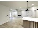 Bright living room with white fireplace and accent wall, and island seating at 3221 N 37Th St # 26, Phoenix, AZ 85018