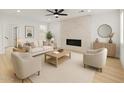 Bright and airy living room with marble fireplace, ceiling fan, neutral furniture, and light wood flooring at 3221 N 37Th St # 26, Phoenix, AZ 85018