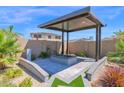 Cozy covered fire pit area, perfect for outdoor entertaining with great landscaping at 3498 E Ravenswood Dr, Gilbert, AZ 85298