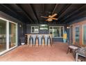 Covered patio featuring a bar, ceiling fan, and brick floor, ideal for outdoor living at 3824 W Carol Ave, Phoenix, AZ 85051