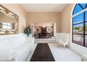Bright living room featuring large arched windows and view into the formal dining room at 3951 E Sequoia Trl, Phoenix, AZ 85044