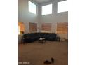 Bright living room featuring high ceilings and large windows at 40724 W Novak Ln, Maricopa, AZ 85138